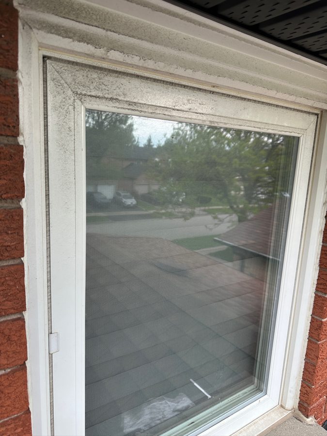 Window with dust and residue before cleaning