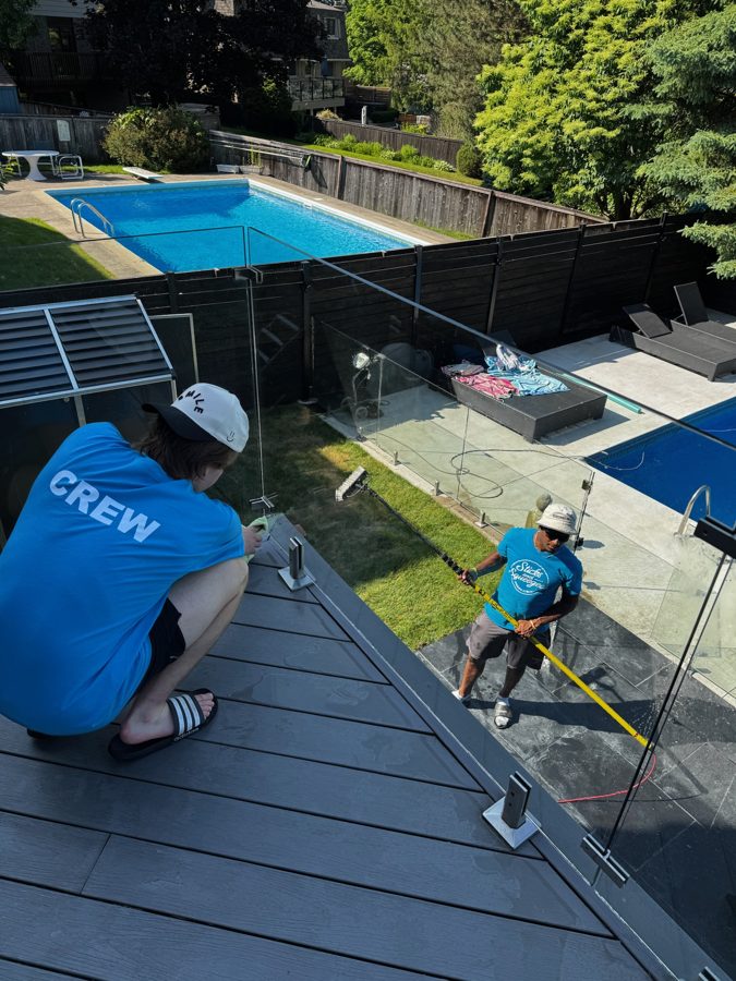 Sticks & Squeegees crew on the job in branded shirts